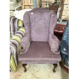 A purple wing back armchair