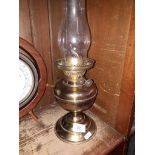 A brass paraffin lamp with glass funnel