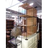 Two metal framed and wicker shelving/storage units