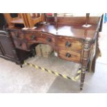 Regency period mahogany sideboard with turned legs and concave centre drawer