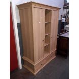 A modern light oak effect wardrobe, width 133cm, depth 59cm & height 195cm.