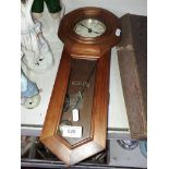 An Edwardian 31 day Regulator wall clock with pendulum and key.