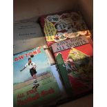 A box of vintage books, including sports books and school excercise books