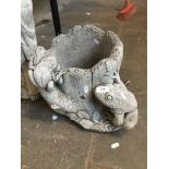 A concrete garden planter featuring frogs