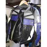 A collection of motorcycle clothing including jacket, trousers, underwear etc