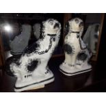 A pair of 19th century Staffordshire pottery spaniels, height 29cm.