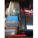 A box of kitchen items including storage and digital scales