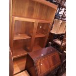 A Parker Knoll teak glazed cabinet and a reproduction bureau