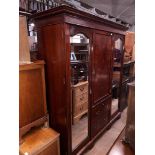 An edwardian inlaid mahogany triple wardrobe