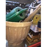 A large plastic garden planter including sprayer and watering can