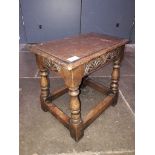 A joined oak stool with carved frieze, early 20th century, height 38cm.