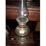 A brass oil lamp with funnel, labled 'MANUFACTURED IN GERMANY FOR S P CATERSON LONDON SE'