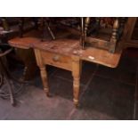 A 19th century pine kitchen drop leaf table with frieze drawer and turned legs, length 116cm, min.