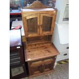 A rustic indian glazed two part cabinet