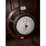 A fisherman's aneroid barometer by Dolland, mounted on ships wheel