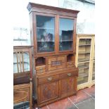 A late Victorian cabinet bookcase with glazed top, base with drop down front revealing fitted