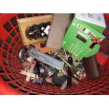 A plastic laundry basket containing metal religious items, spectacles, mobile phone etc