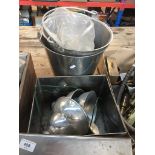 2 stainless steel buckets and a tin containing industrial light shades