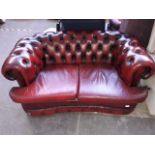 An oxblood leather Chesterfield two seater settee