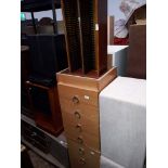 A pair of pine veneered bedside drawers and a cd rack