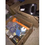 Two boxes of household items including toat=ster, irons, slow cooker, binoculars,