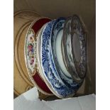 Small box of pottery plates and a wooden bread board