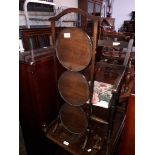 An Edwardian oak cake stand.