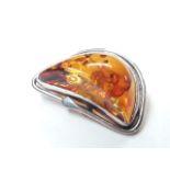 An Art Nouveau style amber pendant brooch, indistinctly marks, length 35mm.