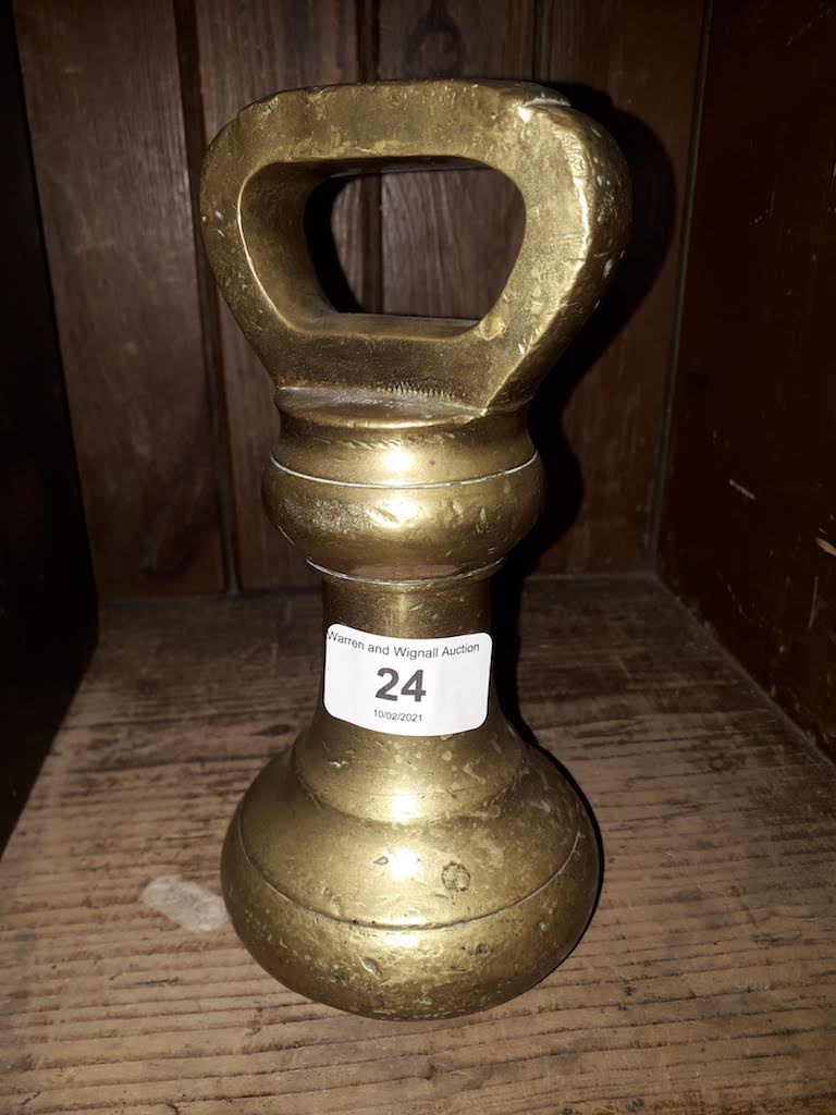 An Avery brass bell weight marked 7 and lb