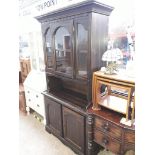 An oak glazed cabinet bookcase