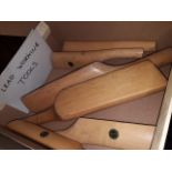 A box of wooden lead working tools