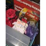 A misc box with drinking game, artificial roses, document case etc
