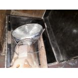 A metal box containing car headlight, axe and saw