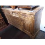 A large pine sideboard, H91cm, L182cm, D48cm. (no handles)