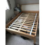 A beech wood double bed, with beech and velour headboard.