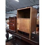 A utilitarian walnut bedside cabinet and a small chest of drawers with magazine stands.