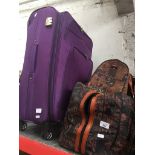 A suitcase, a large holdall containing other bags and a small holdall containing wallets