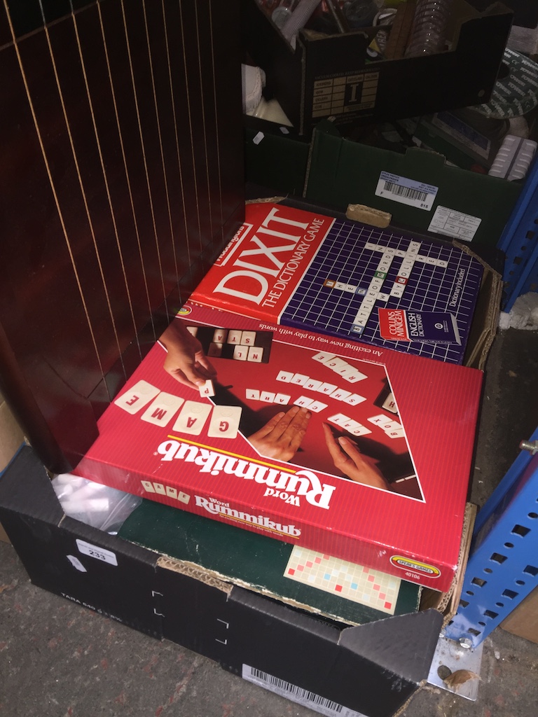 A box of games including shove halfpenny board