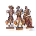 A group of three eastern mixed media sculptures, height 31cm.