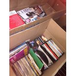2 boxes containing a mix of 45s, cassettes and CDs