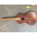 A vintage hand made acoustic guitar with wooden tuning pegs