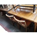 An oak drawer leaf table and four chairs