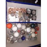 A mixed box of marbles, gold balls and coins.