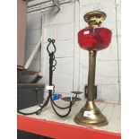 Oil lamp with brass column stem and cranberry glass well and hanging candle holder