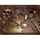 A box of brass including light fittings, clock, caddy spoon, bell, candlestick etc.