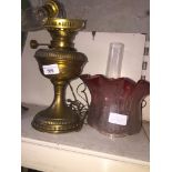 Brass converted oil lamp with funnel and pink frilled shade