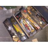 A metal toolbox and contents