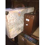 A small suitcase and a cardboard storage box/suitcase