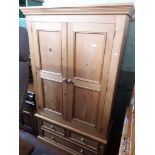 A pine wardrobe, H192cm, W110cm, D58cm.