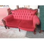 A continental style wood frame settee.